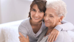 Happy elderly woman with her daughter at home