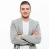 portrait-successful-man-having-stubble-posing-with-broad-smile-keeping-arms-folded_171337-1267_ins